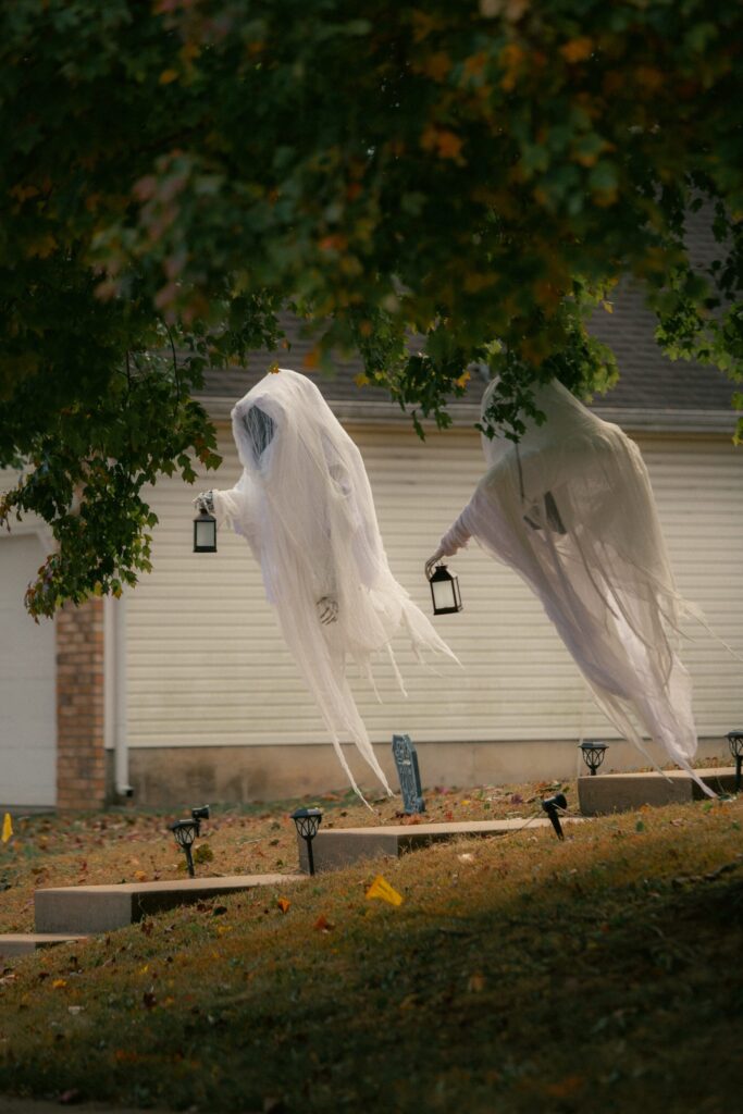 A image of a white ghost hang on a tree