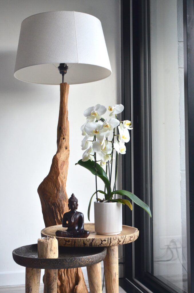 A wooden lamp stand with a picture of a wooden figure