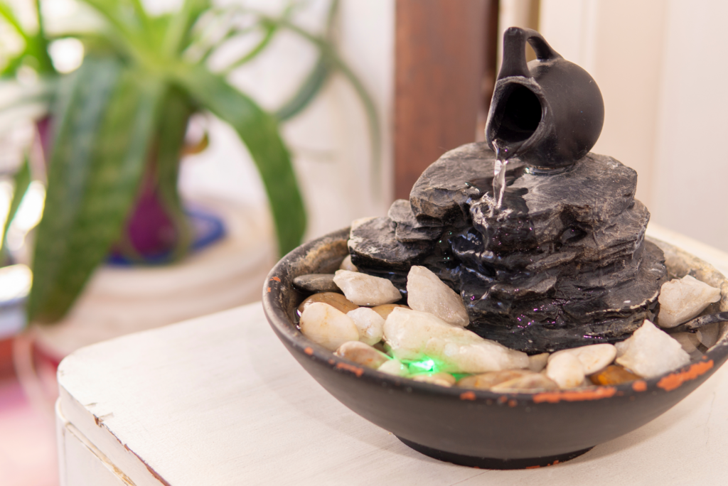 A DIY table fountain with stones and jar accent