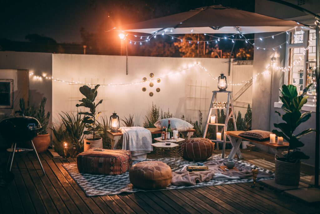 Outdoor nature theme with wooden accents, cushions and fairy lights