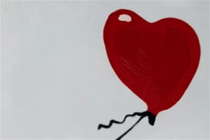 A detail look of a hear shaped ballon hand painted