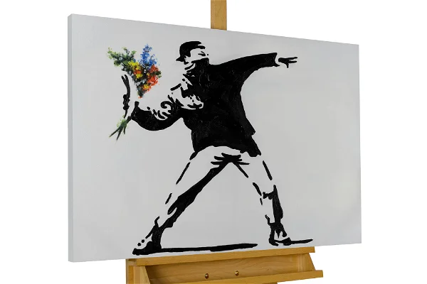 A guy is throwing a bouquet of folower in a landscape painting.