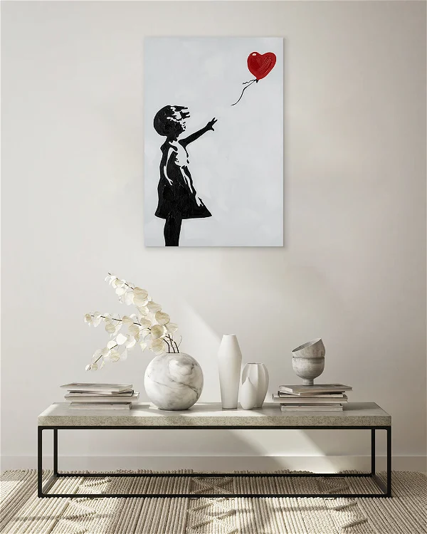 A living room with a poster painting of a girl reaching a heart-shaped balloon