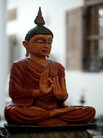 houten sculptuur van een mediterende boeddha