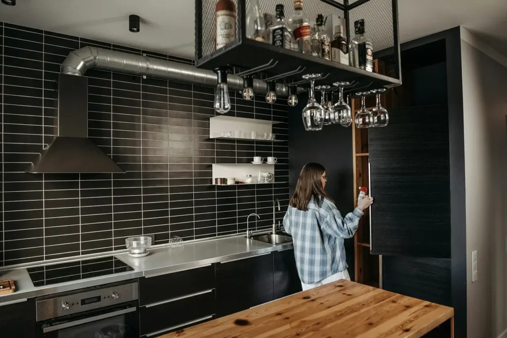 A woman looking at the cupboard in an industrial kitchen background