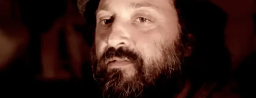 An image of a man with beard and curly hair