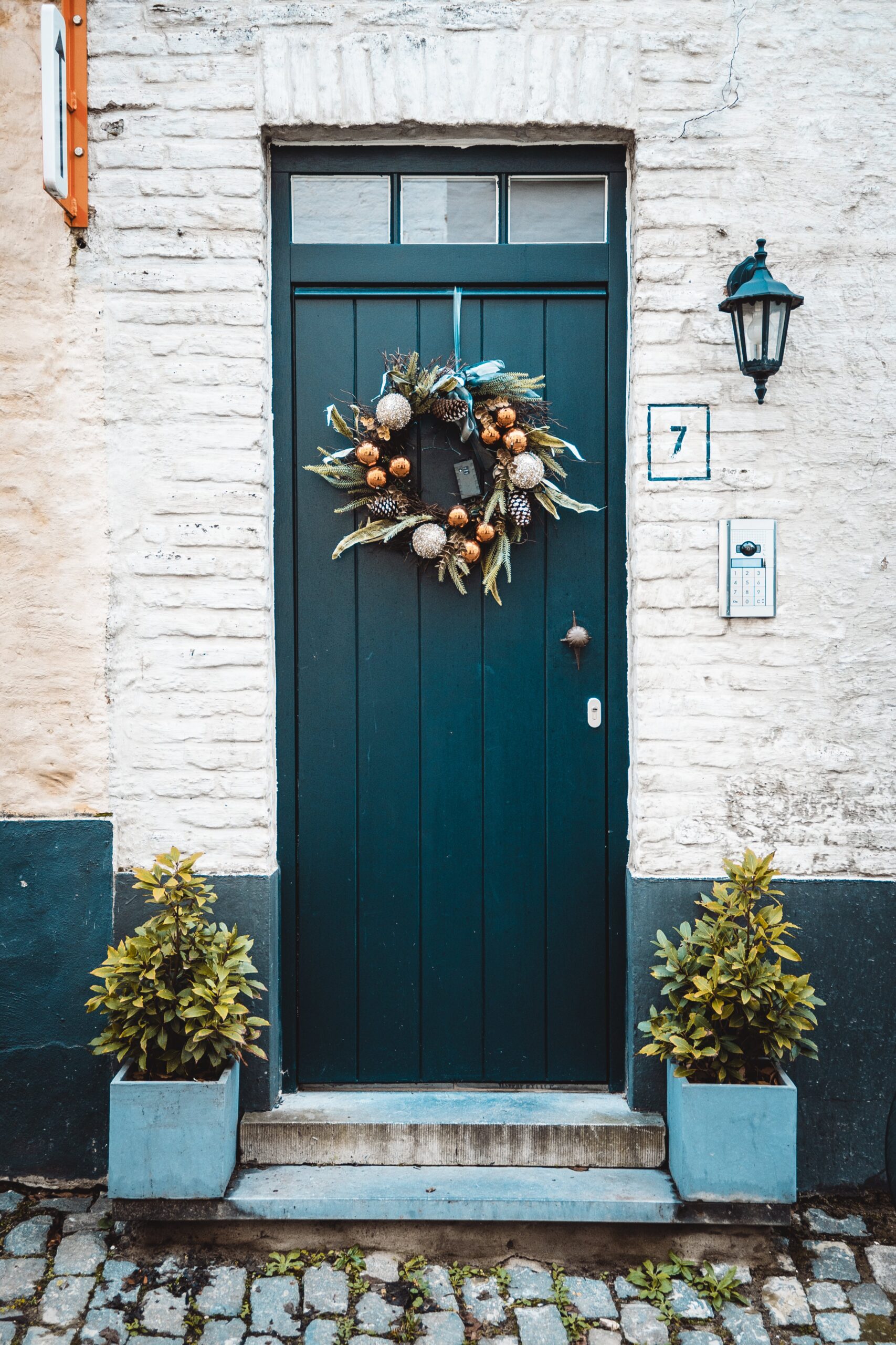 a picture with wreaths on the entrance door